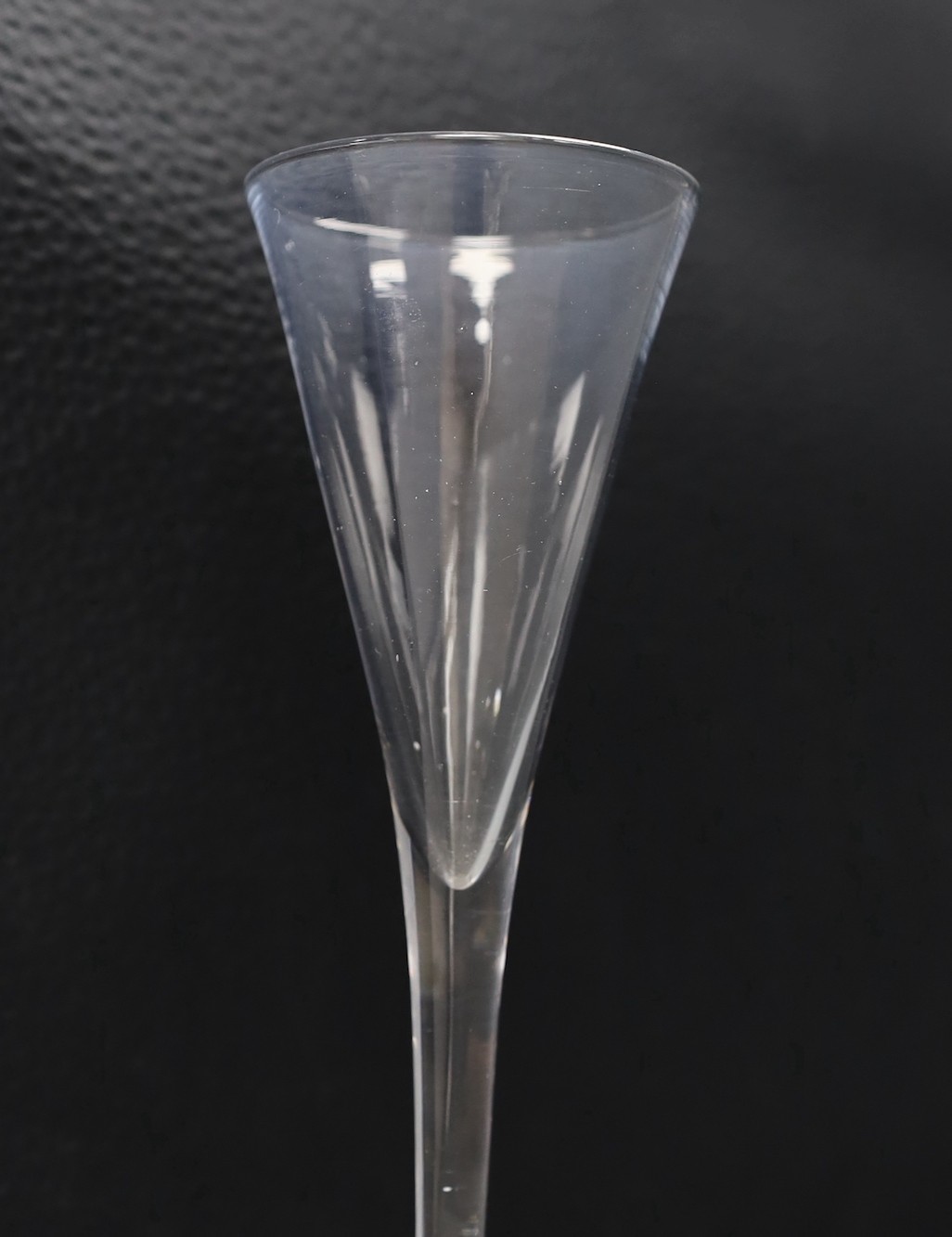 An 18th century toasting glass, 19cms high